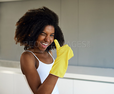Buy stock photo Cropped shot of an attractive young woman wearing yellow rubber gloves showing a thumbs up at home