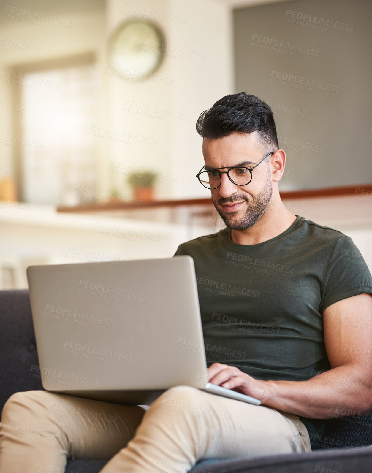 Buy stock photo Typing, laptop and man with glasses, home and research for project, video editing and social media in lounge. Content creation, digital and busy in living room, creative and remote work in house