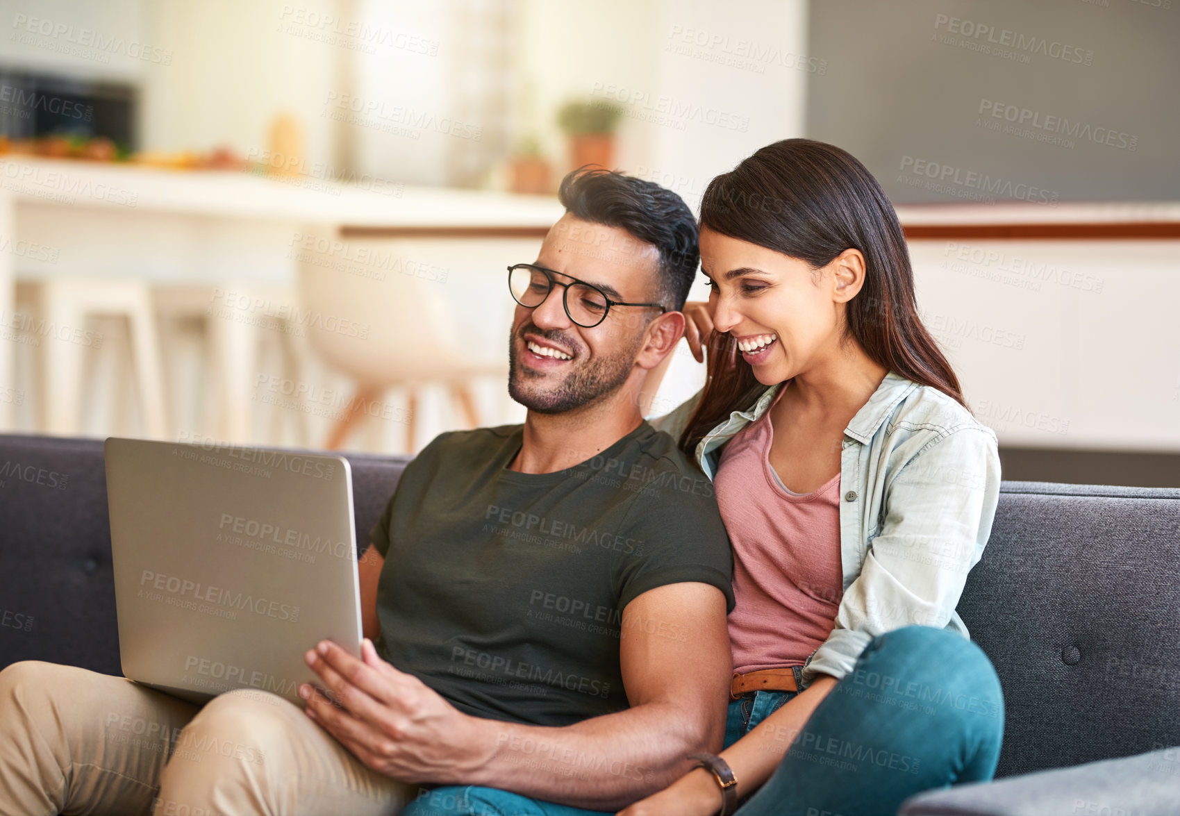 Buy stock photo Shot of a young couple using a laptop together at home