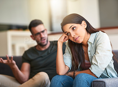 Buy stock photo Shot of a young woman looking unhappy after having a fight with her partner at home