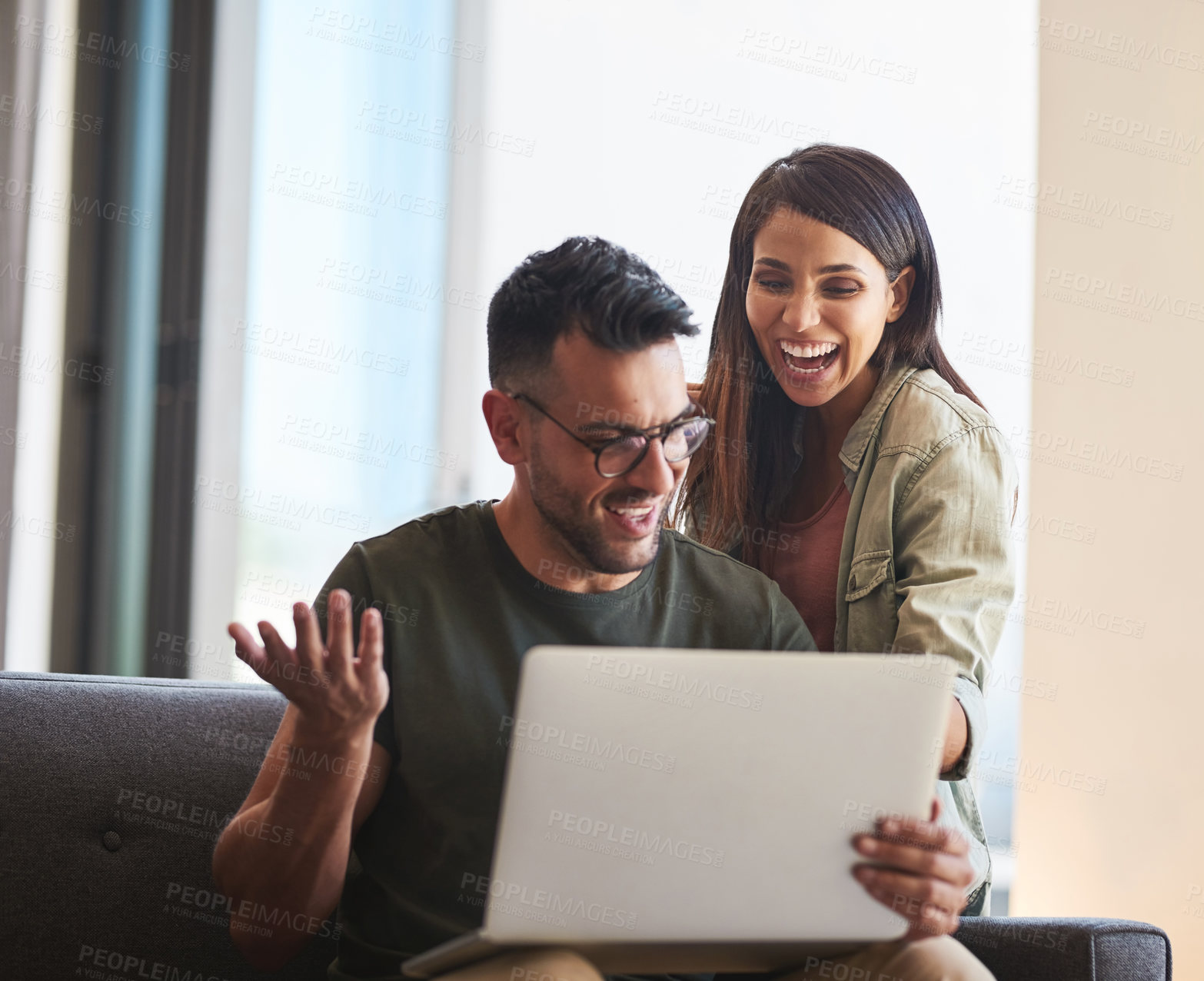 Buy stock photo Shot of a young couple using a laptop together at home