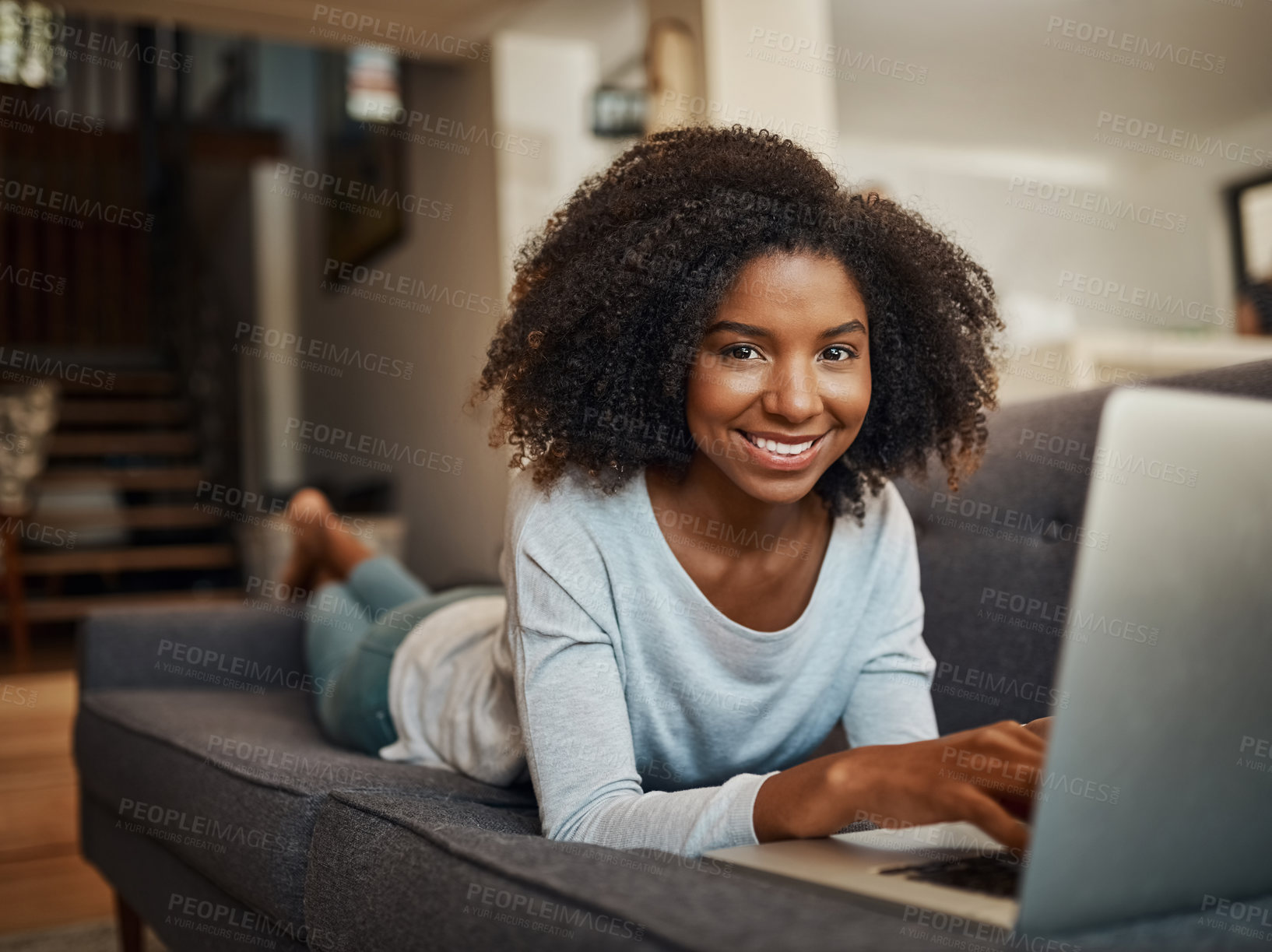 Buy stock photo Portrait of an attractive young woman using a laptop at home