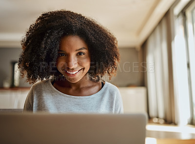 Buy stock photo Portrait of an attractive young woman using a laptop at home