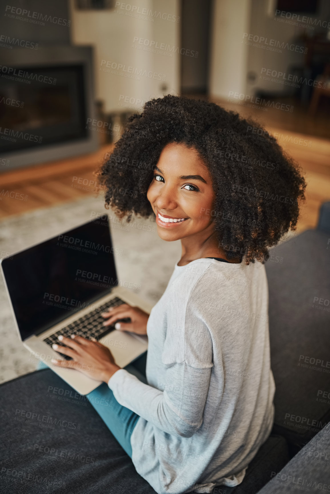 Buy stock photo Portrait of an attractive young woman using a laptop at home