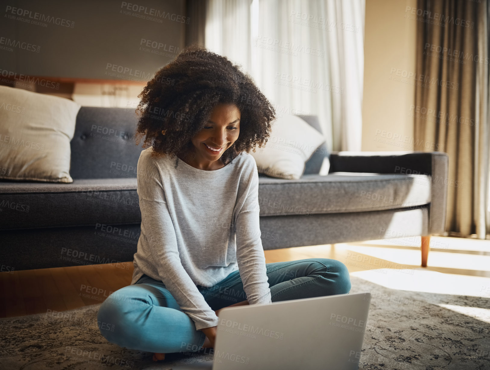 Buy stock photo Shot of an attractive young woman using a laptop at home