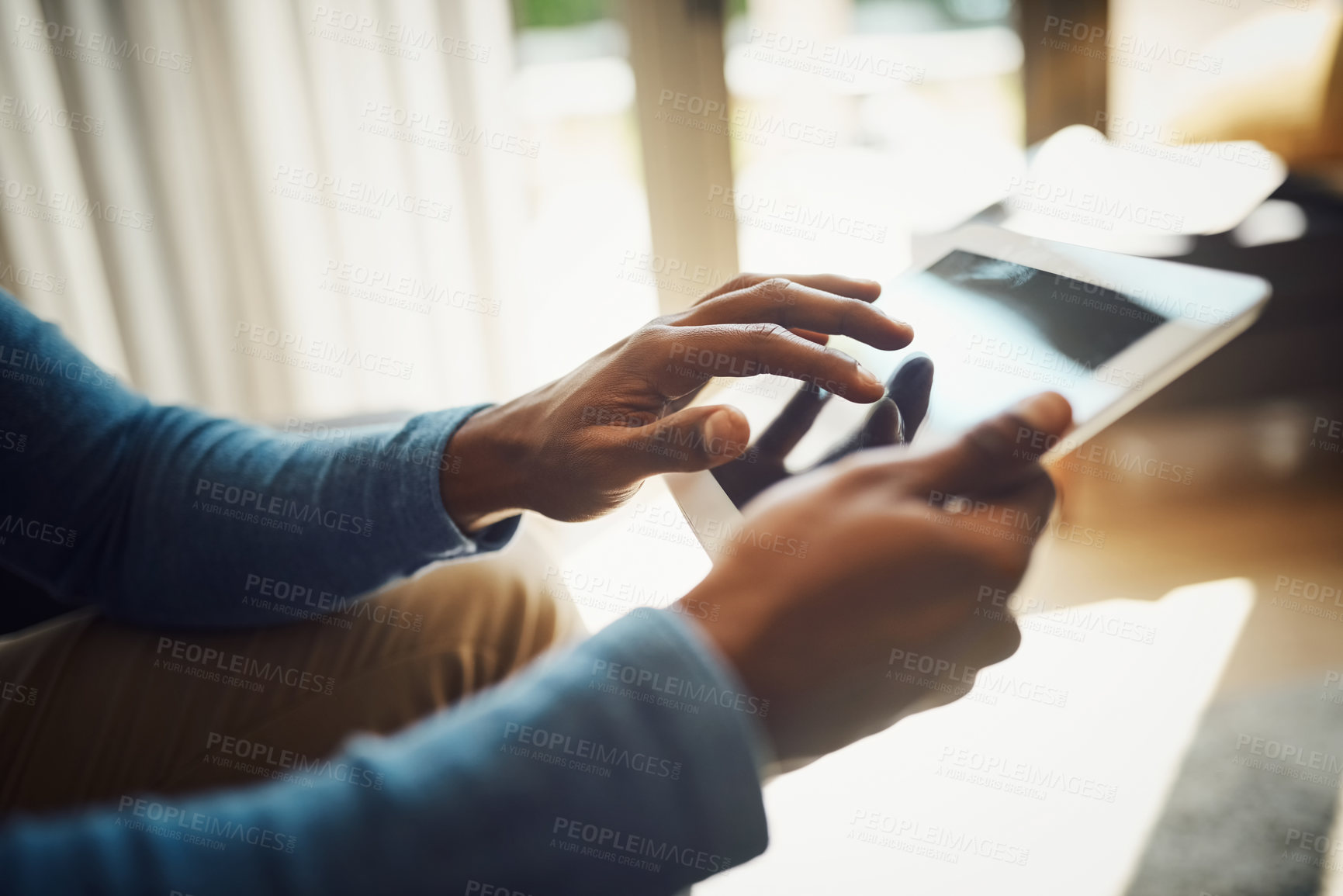 Buy stock photo Closeup shot of an unrecognizable man using a digital tablet at home