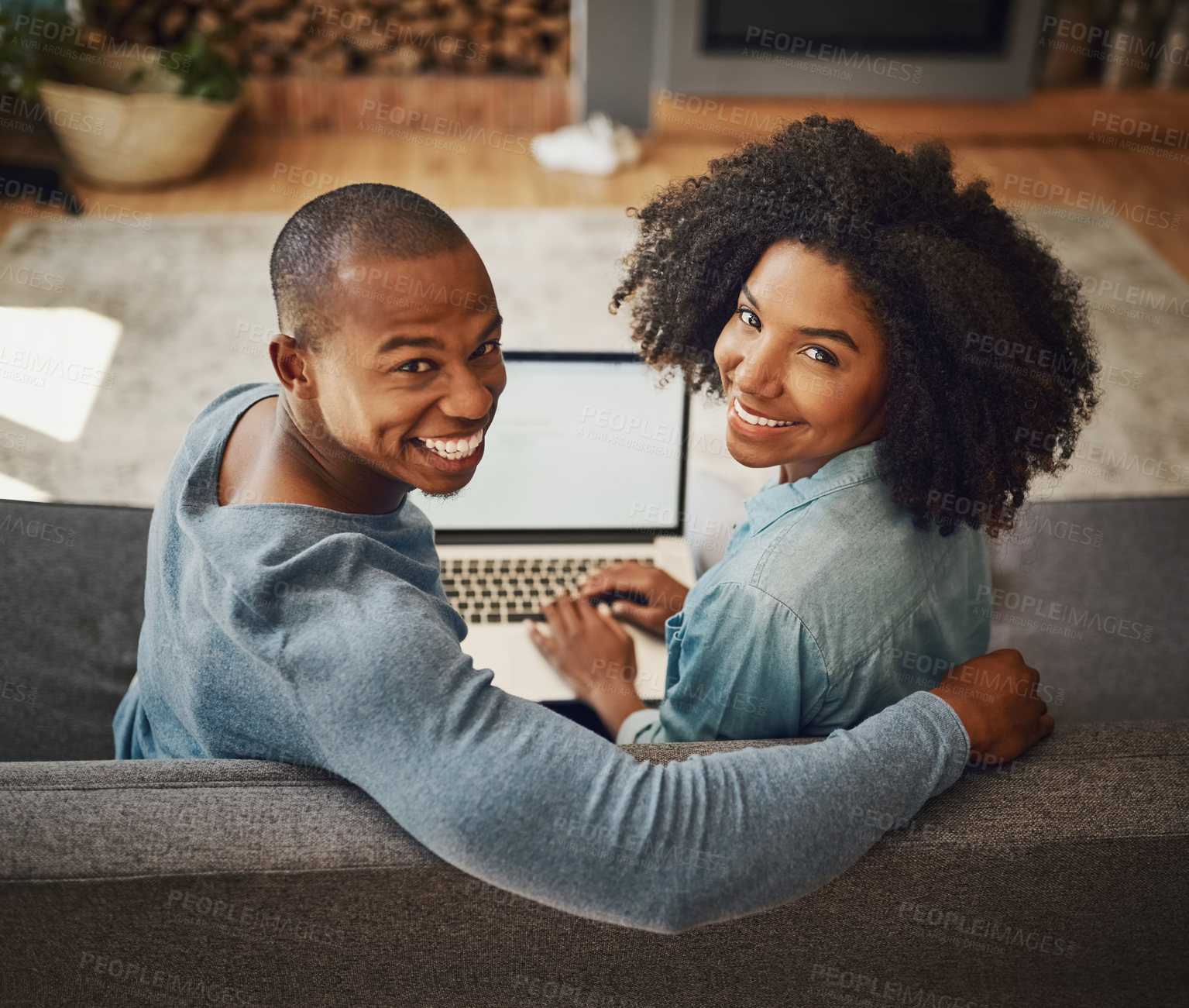 Buy stock photo Portrait of an affectionate young couple relaxing at home