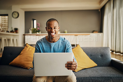 Buy stock photo Portrait of a handsome young man using a laptop at home