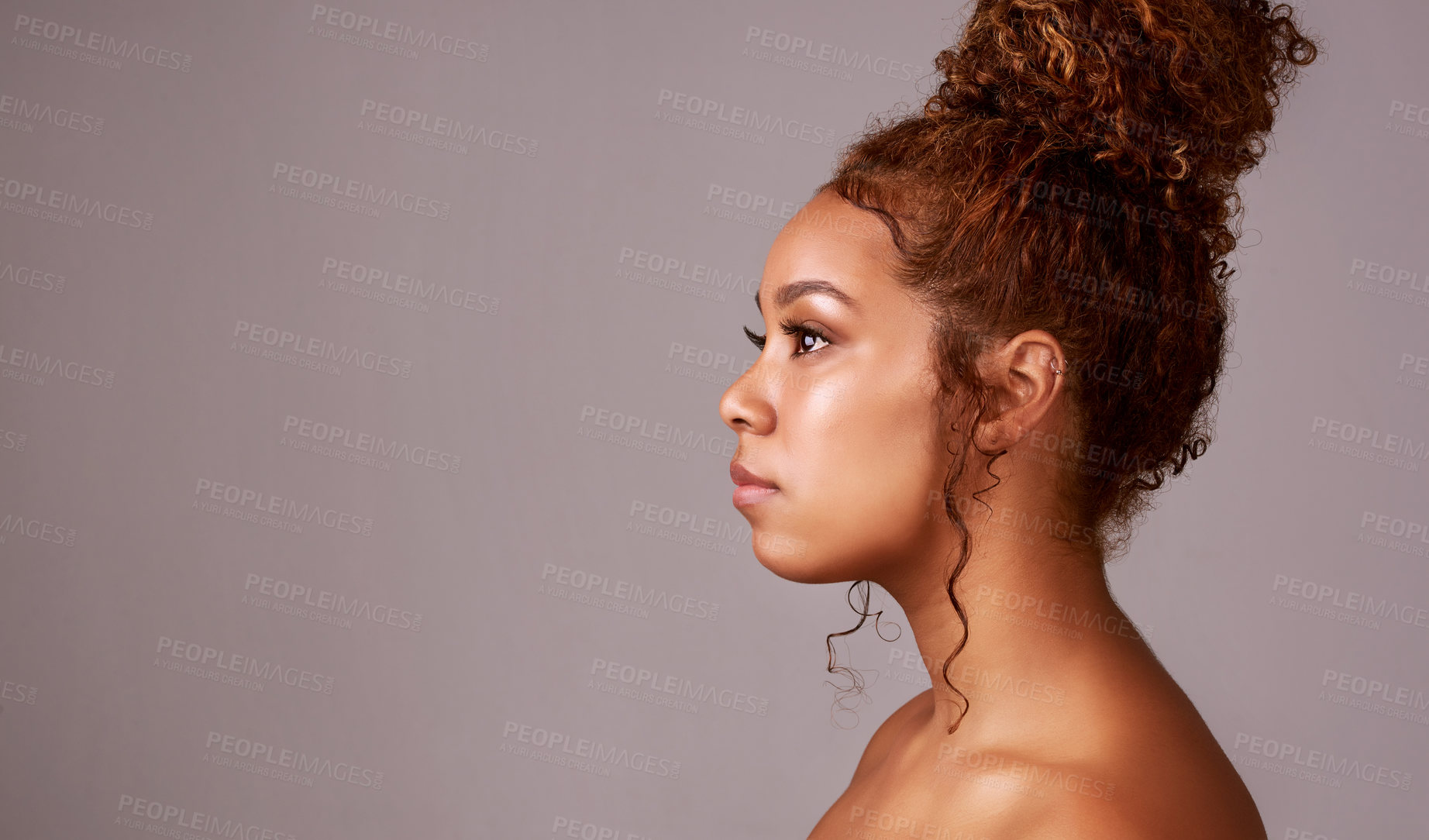 Buy stock photo Studio shot of a beautiful young woman posing against a gray background