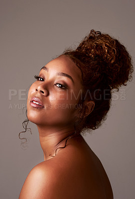 Buy stock photo Studio shot of a beautiful young woman posing against a gray background