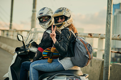 Buy stock photo Cropped shot of a young attractive couple riding a scooter around town