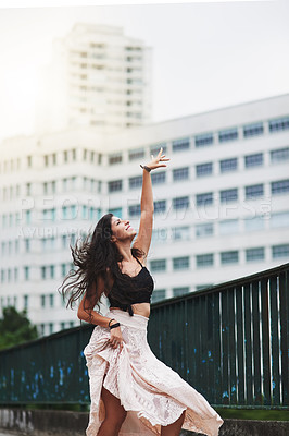 Buy stock photo Shot of an attractive young woman dancing in the city