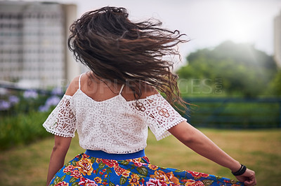 Buy stock photo Rearview shot of a young woman dancing in the city