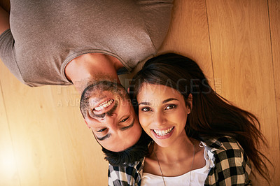 Buy stock photo Portrait of a young couple relaxing together at home