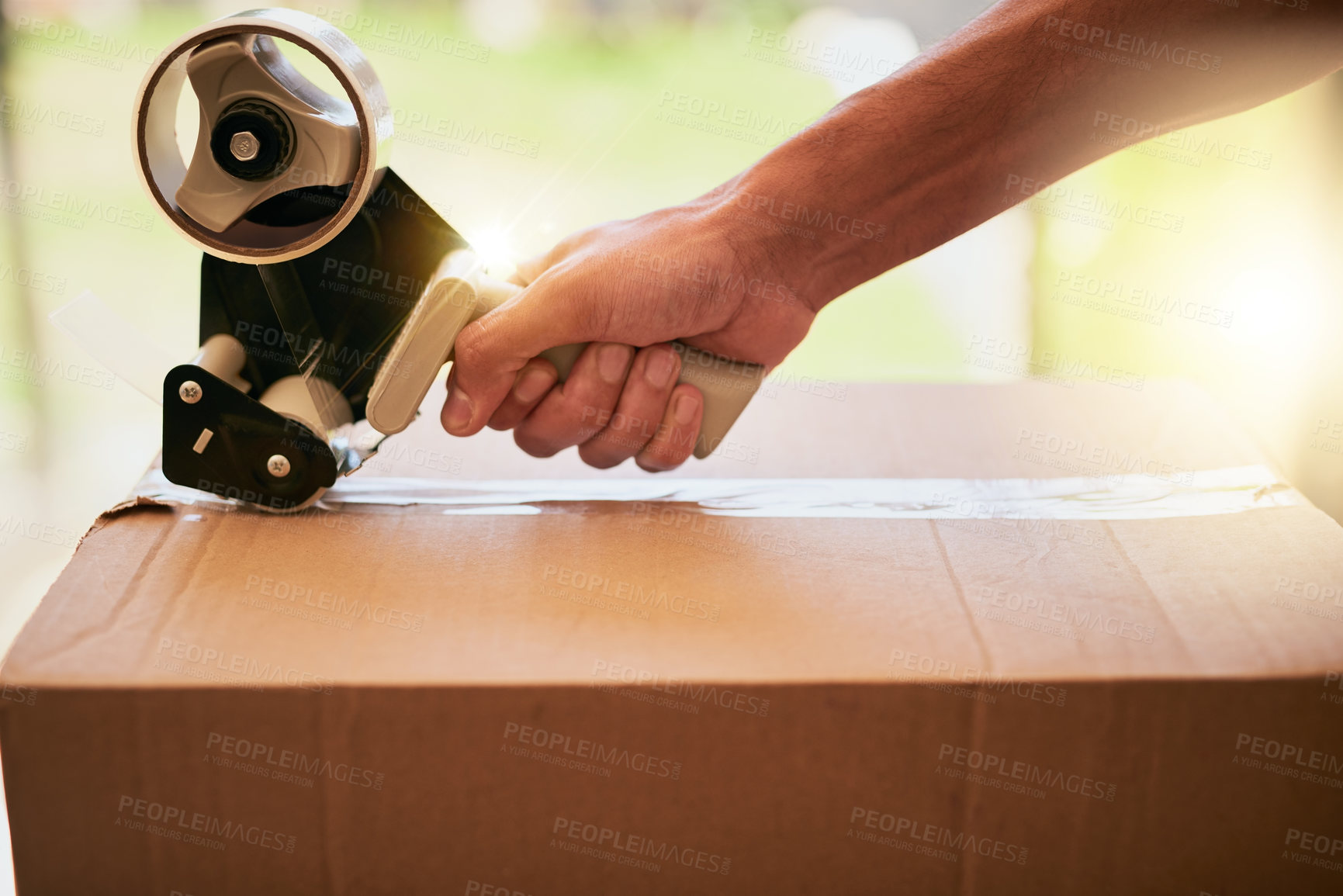 Buy stock photo Closeup shot of an unrecognizable man closing a cardboard box with tape