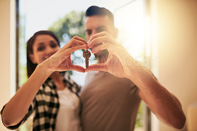 Buy stock photo Heart, hands and couple with a keys, home and happiness for growth, development and real estate. Partners, man and woman with new property, symbol for love and goals with achievement and apartment