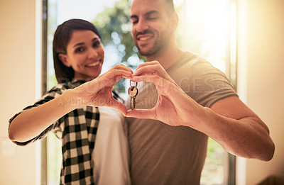 Buy stock photo Portrait of a young couple holding the keys to their new home
