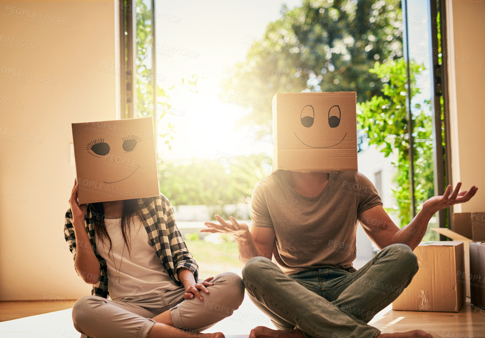 Buy stock photo Couple, play and cardboard with boxes on head for moving day, comedy renovation and property investment. People, funny drawing and new house with future security, comic celebration and emoji game 