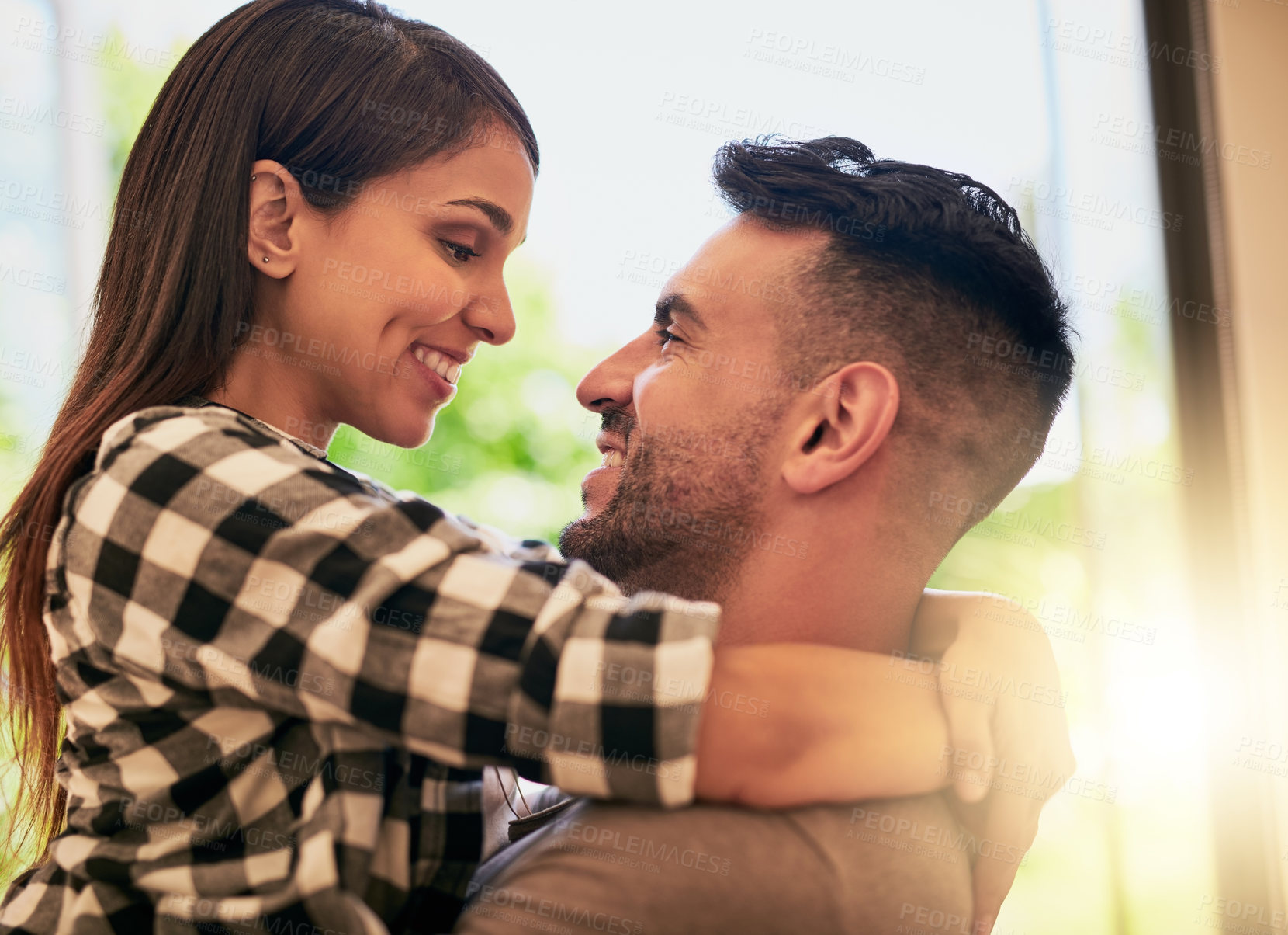 Buy stock photo Shot of an affectionate young couple bonding at home