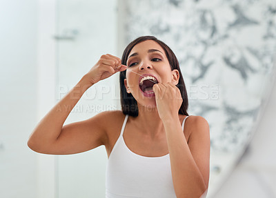 Buy stock photo Woman, dental habit and flossing teeth in home, orthodontics and cosmetics in bathroom. Female person, oral health and string for grooming or treatment, cleaning and self care or thread for plaque