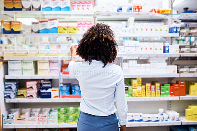 Buy stock photo Back, pharmacy and medication with a woman customer buying medicine from a shelf in a dispensary. Healthcare, medical or treatment with a female consumer searching for a health product in a drugstore