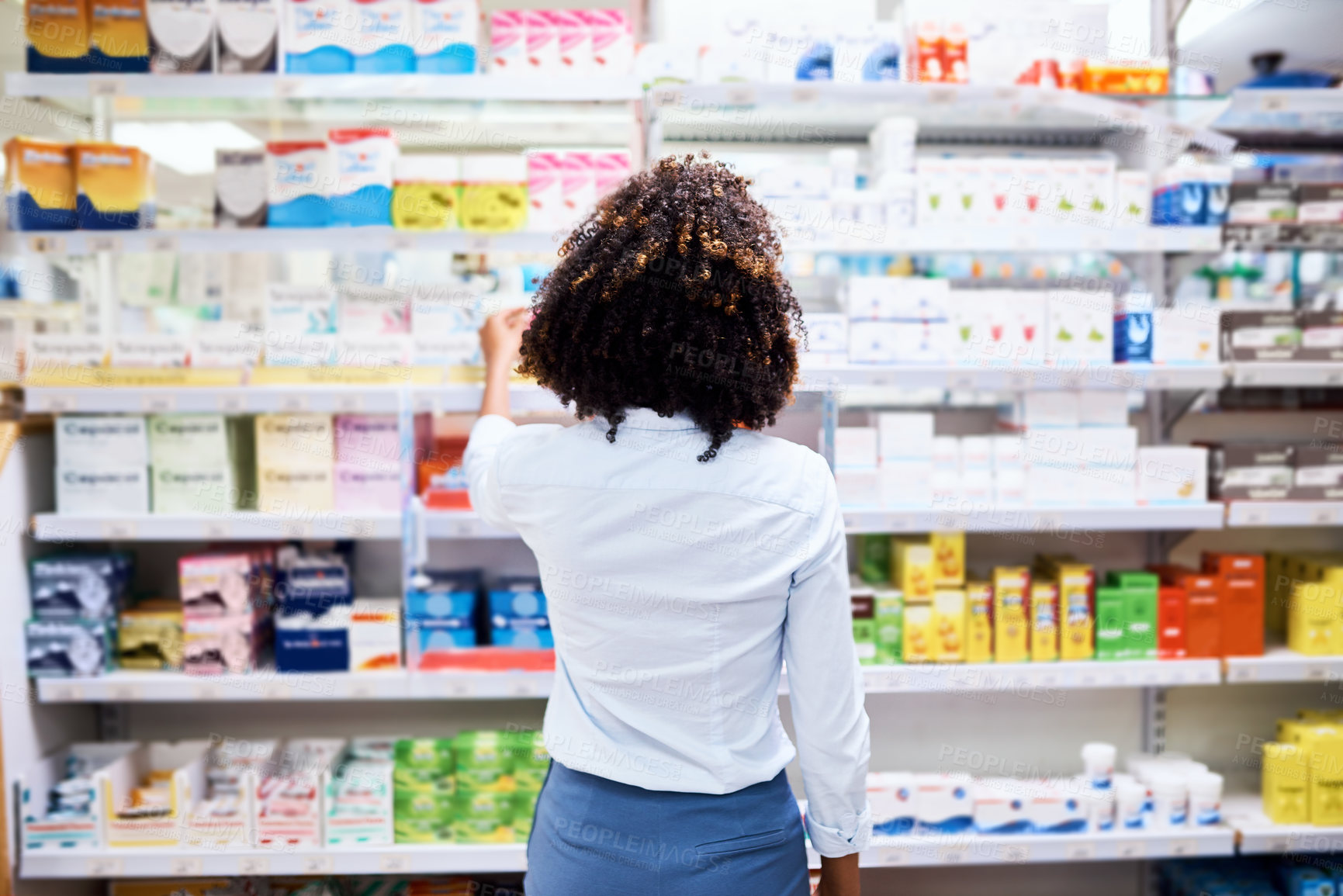 Buy stock photo Back, pharmacy and medication with a woman customer buying medicine from a shelf in a dispensary. Healthcare, medical or treatment with a female consumer searching for a health product in a drugstore