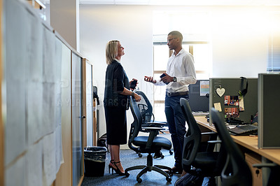 Buy stock photo Shot of two businesspeople having a discussion in an office