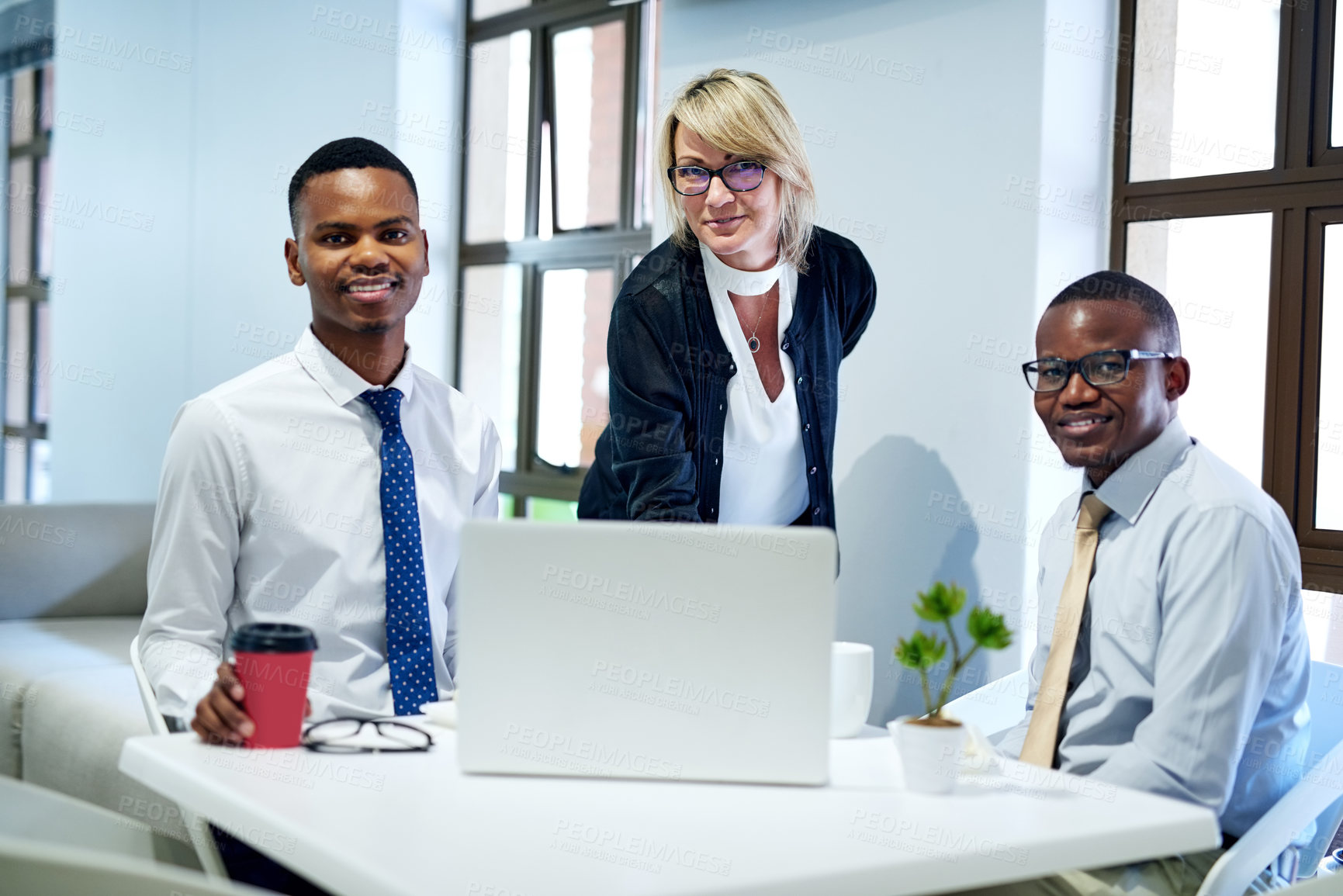 Buy stock photo Portrait of a group of businesspeople working together on a laptop in an office