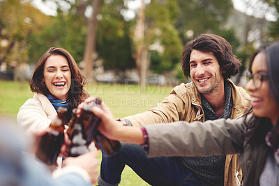 Buy stock photo Nature, smile and friends with beer for toast, celebration and bonding together in social gathering. Group, happy people and bottles with alcohol for achievement, reunion and cheers in outdoor picnic