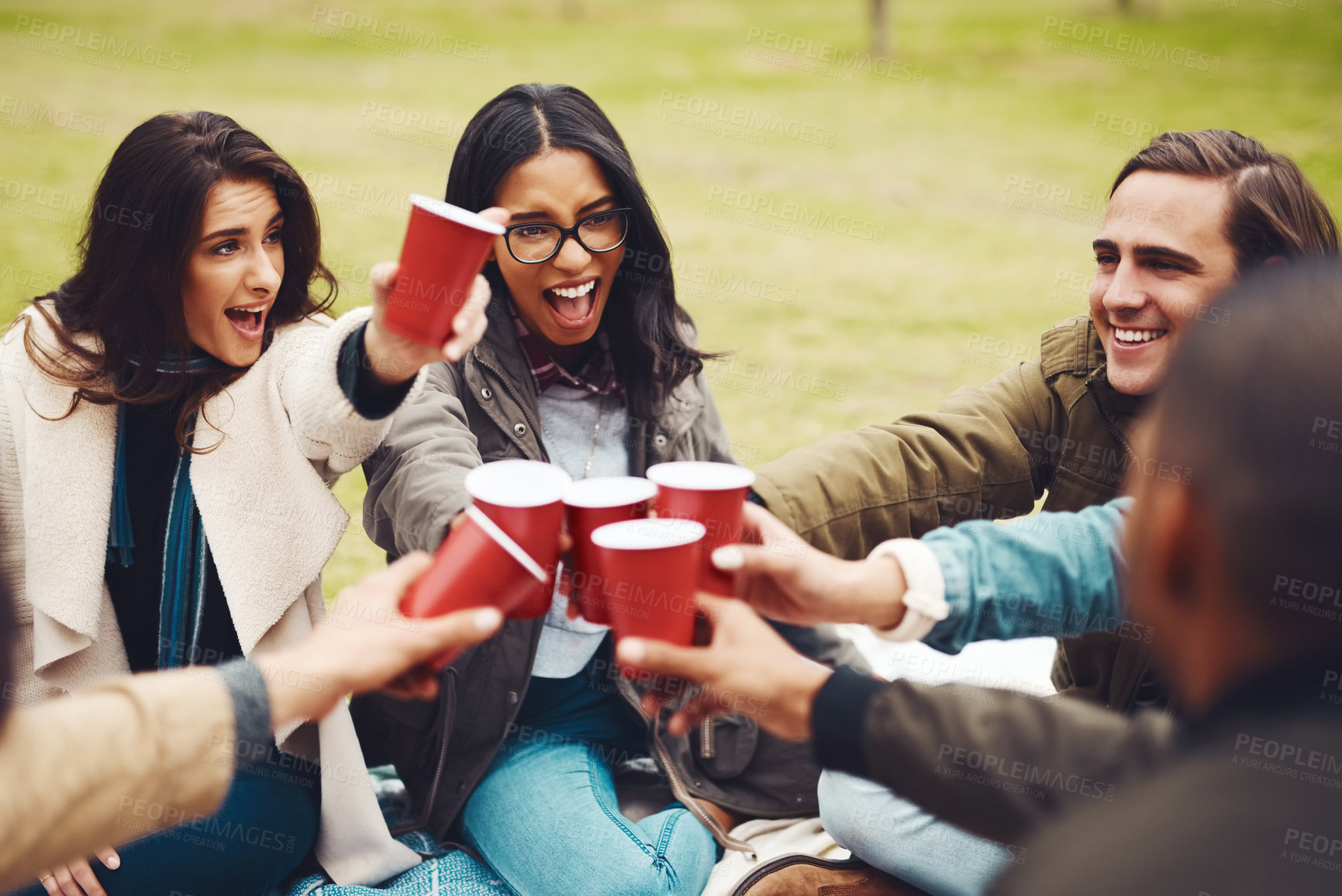 Buy stock photo Park, happy and friends with drink for toast, celebration and bonding together in social gathering. Screaming, people and glasses with alcohol for achievement, reunion and cheers in outdoor picnic