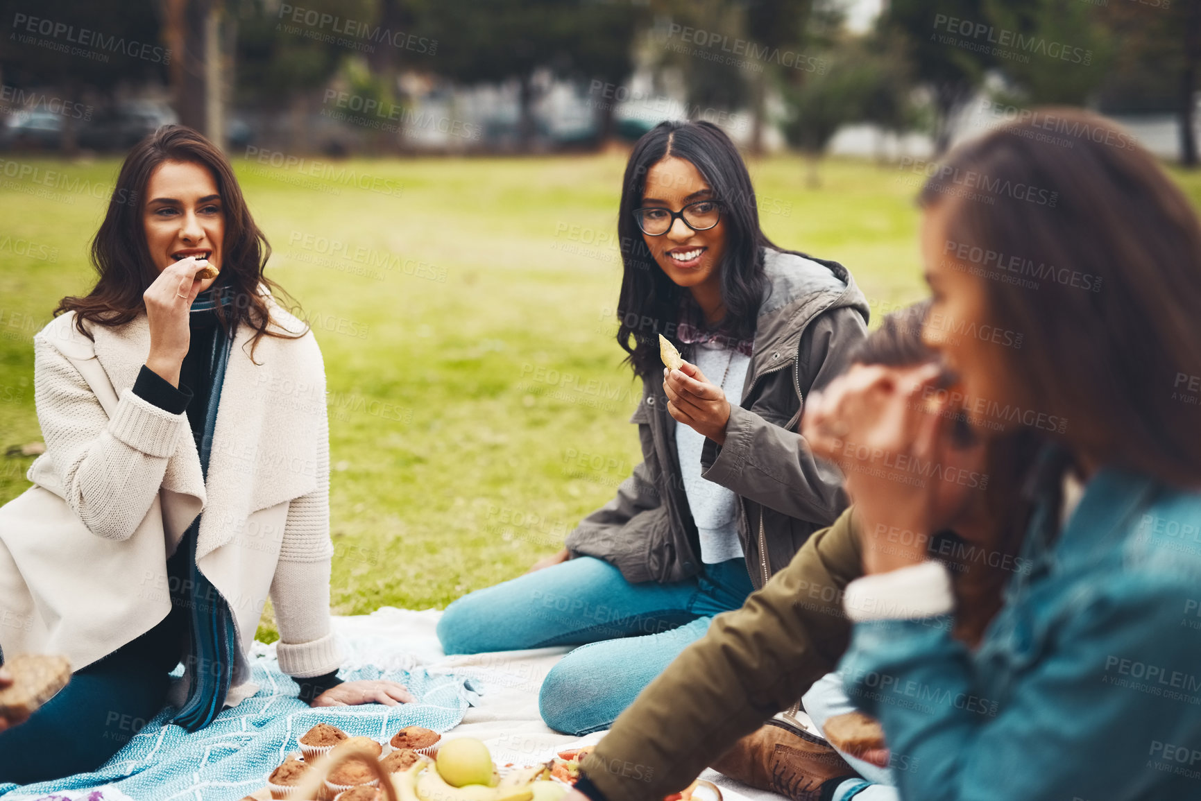 Buy stock photo Friends, food and outdoor picnic at park, nutrition and together for bonding in countryside. People, grass and support on trip to Rio de Janeiro, healthy meal and travel group on weekend holiday