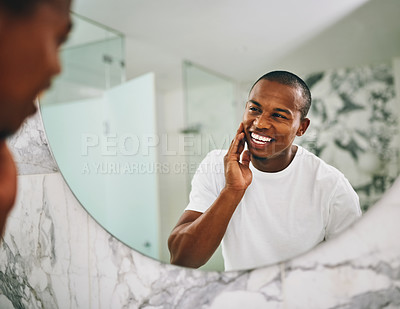 Buy stock photo Shot of a young man going through his morning routine in the bathroom at home