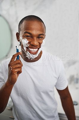 Buy stock photo Black man, smile and shaving with blade, soap or grooming in mirror for self care in home bathroom. African guy, foam or cream for facial hair removal, razor or clean for hygiene in morning at house
