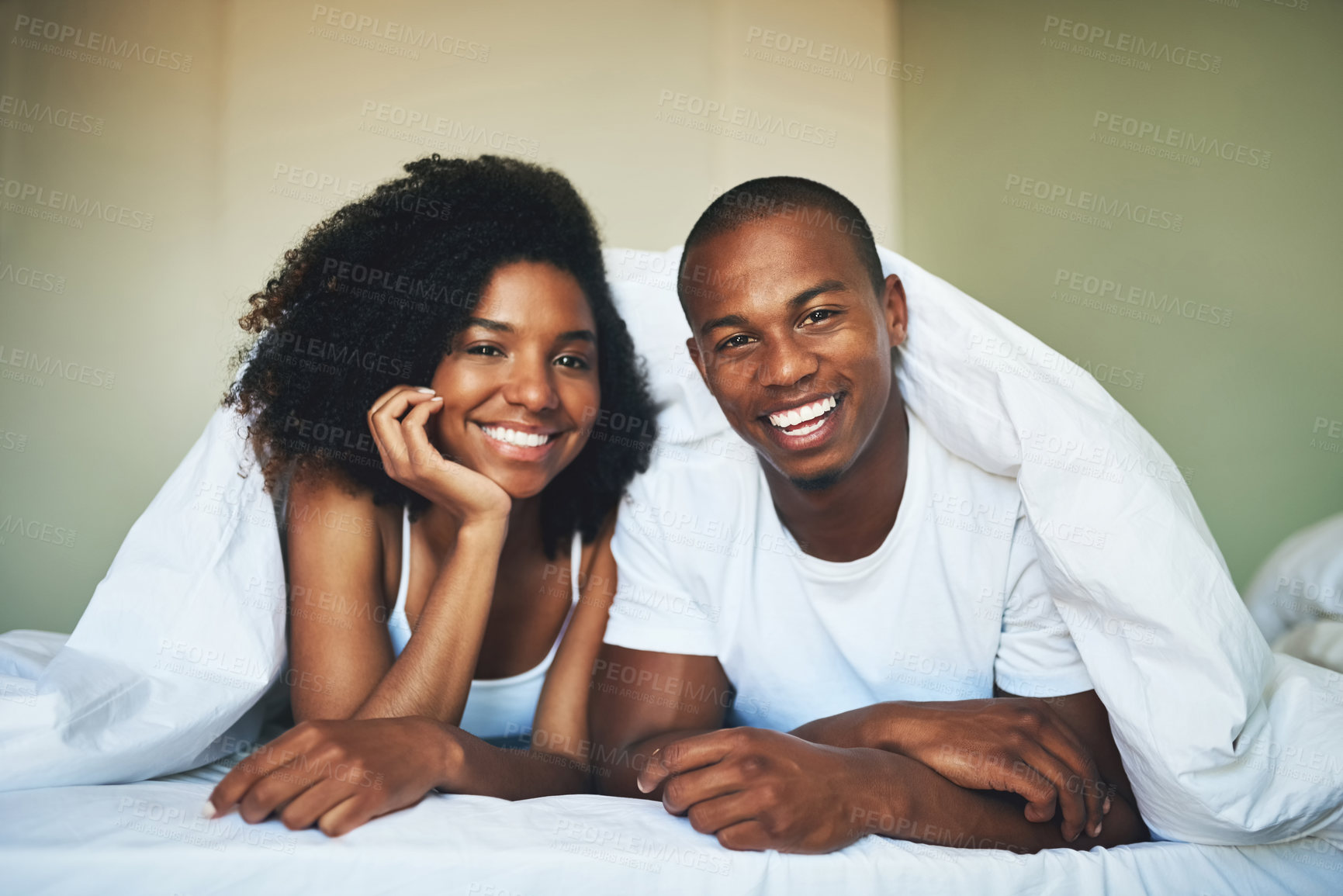 Buy stock photo Duvet, portrait and smile of couple in bedroom of home together for morning bonding or romance. Blanket, love and relax with happy African man and woman in bed for anniversary, holiday or vacation