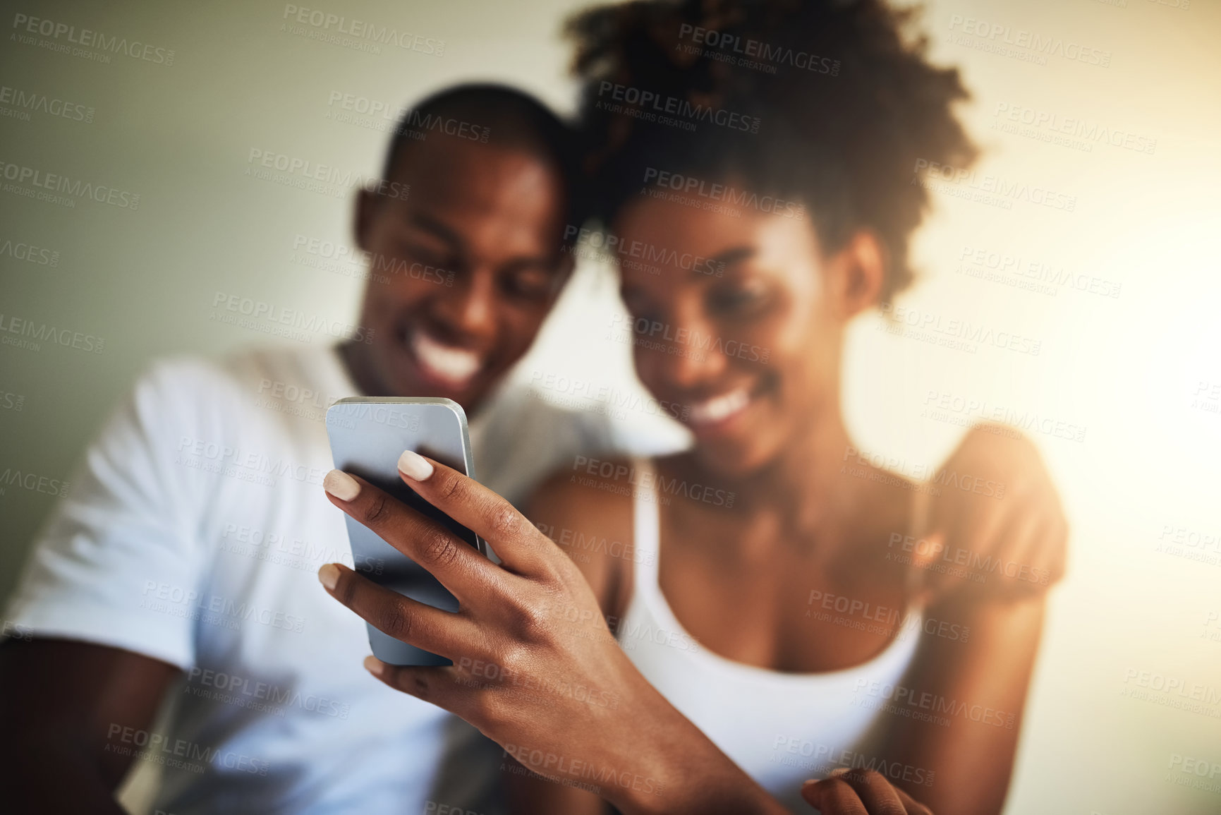 Buy stock photo Hand, cellphone and texting in home with happy couple for communication, social media app and meme together. Black man, woman and smartphone in house with reading, online chat and watch funny video