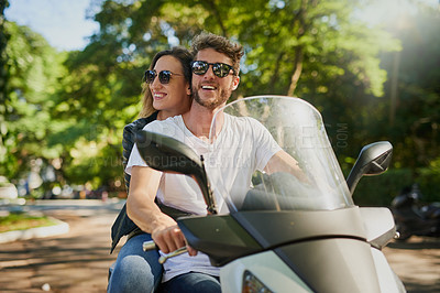 Buy stock photo Cropped shot of a young attractive couple riding a scooter around town