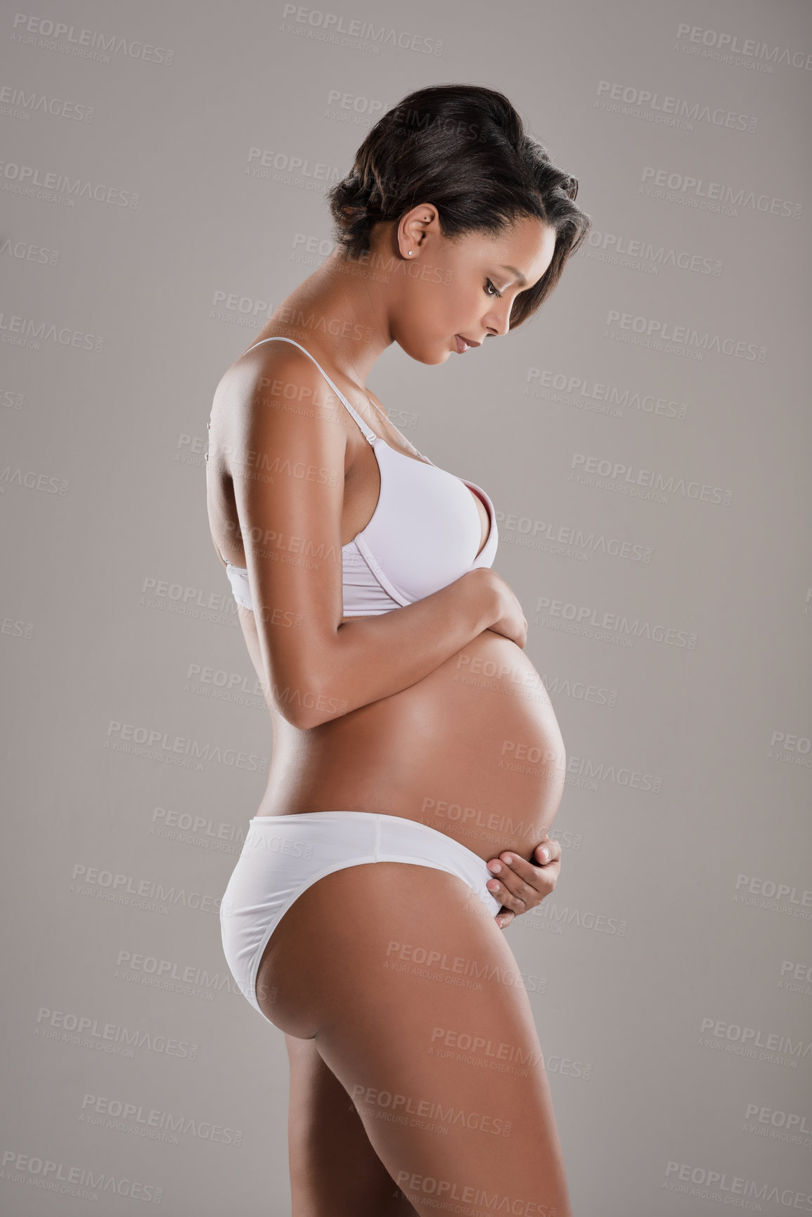 Buy stock photo Pregnancy, woman and stomach with mom love, care and underwear with lingerie and bonding. Studio, pregnant and profile with thinking, maternity announcement and belly with grey background and body