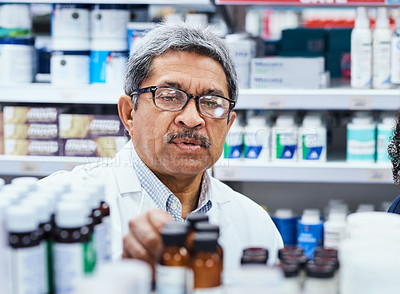 Buy stock photo Shot of a mature pharmacist working in a chemist