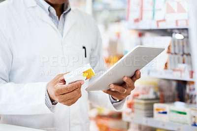 Buy stock photo Closeup shot of an unrecognizable pharmacist using a digital tablet in a chemist