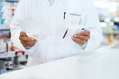 Buy stock photo Closeup shot of an unrecognizable pharmacist holding prescription medication in a chemist