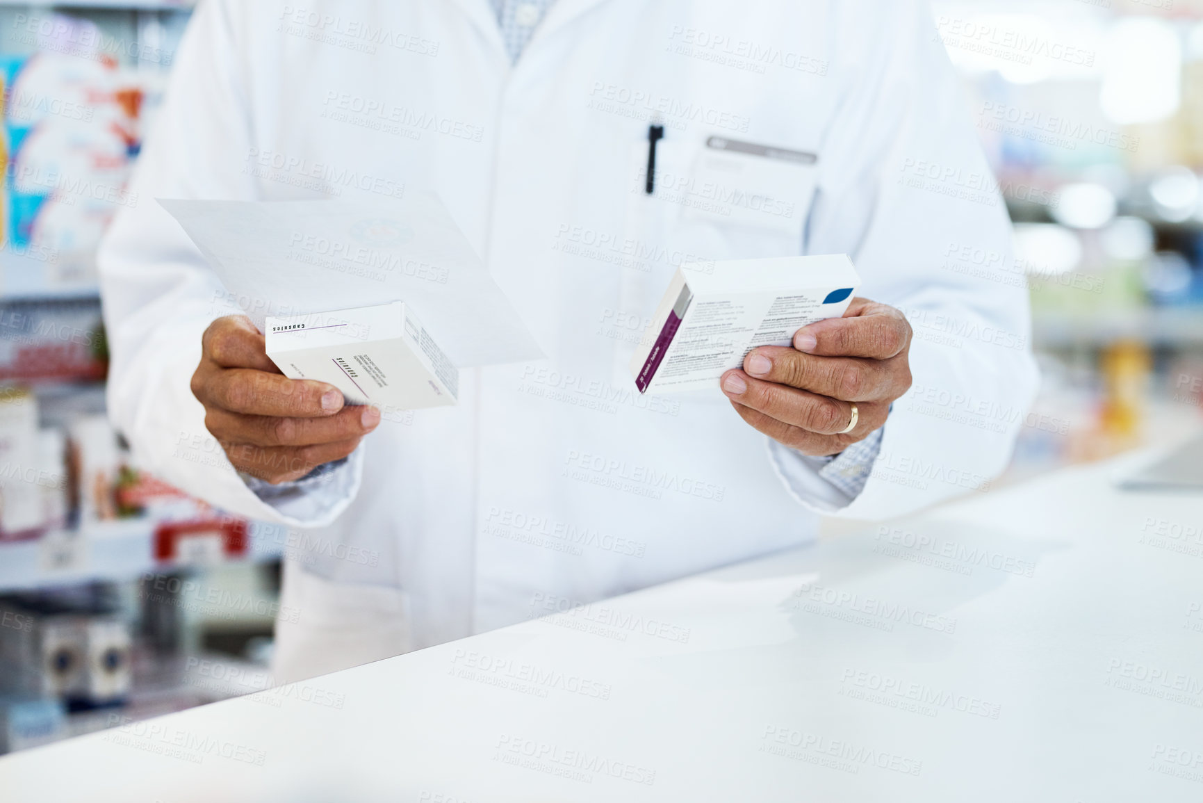 Buy stock photo Closeup shot of an unrecognizable pharmacist holding prescription medication in a chemist