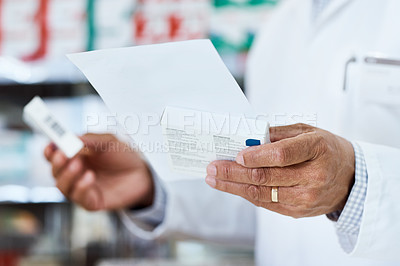Buy stock photo Closeup shot of an unrecognizable pharmacist holding prescription medication in a chemist