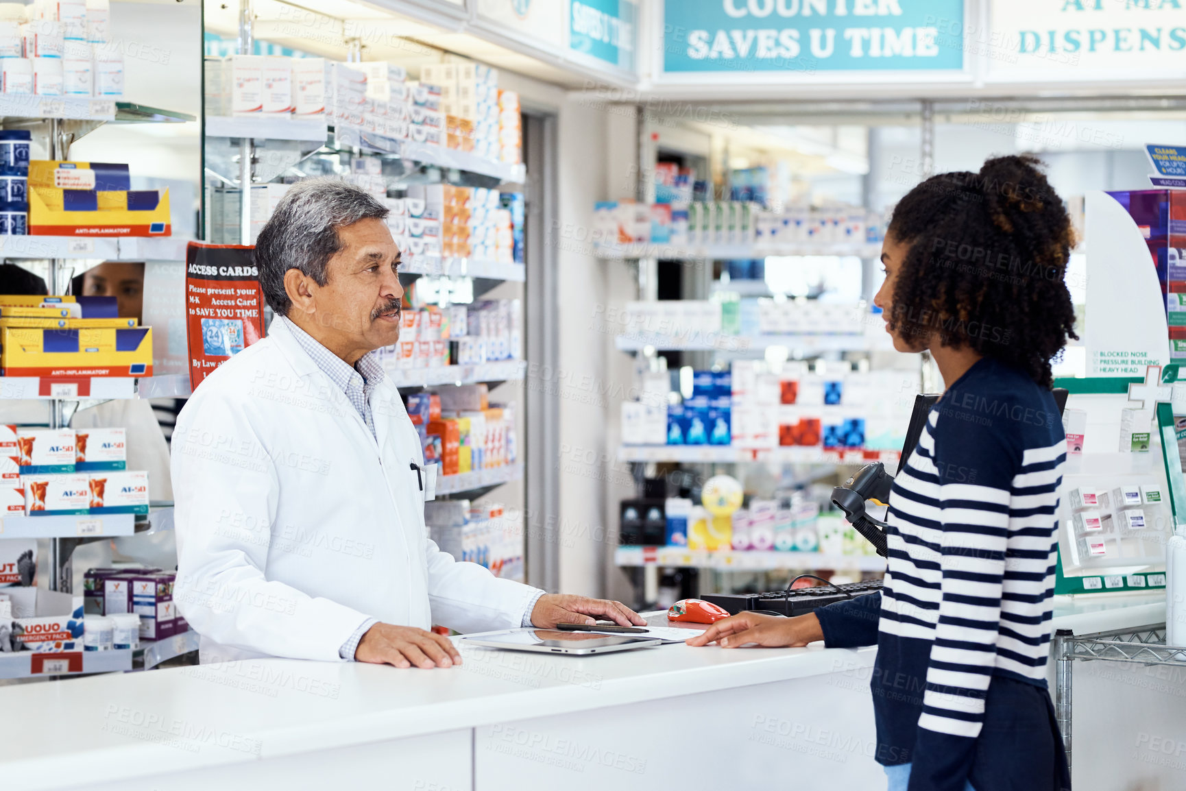Buy stock photo Mature, pharmacist and consulting with woman for help, prescription medication and wellness management. Female customer, man and speaking by counter for advice on medical treatment and healthcare.