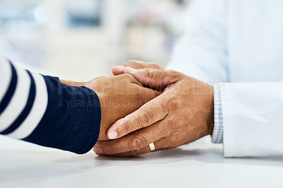 Buy stock photo Closeup shot of a pharmacist holding a customer’s hand in a chemist