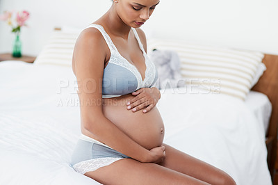 Buy stock photo Pregnancy, woman and stomach care in bedroom with new mother love, support and underwear in morning. Bed, pregnant and relax with thinking, maternity wellness and belly with home, ideas and calm