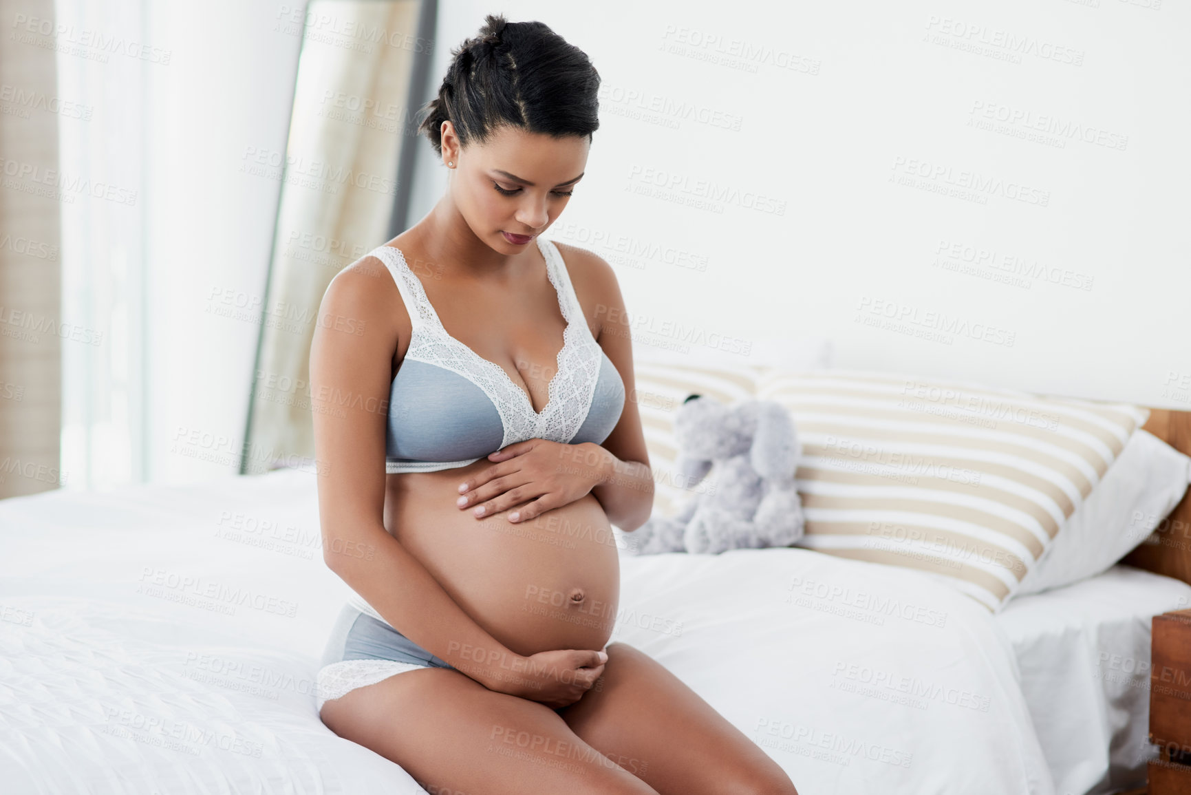 Buy stock photo Bed, relax and pregnant woman with stomach for touching, feeling and growth for baby development. Home, female person and wake up in morning for motherhood, pregnancy and connect with fetus in house