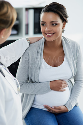 Buy stock photo Pregnant woman, smile and doctor in a hospital at baby check up with happiness. Stomach, pregnancy and healthcare with a professional in clinic with a African female patient in wellness consultation