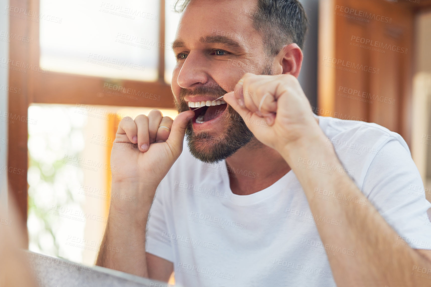 Buy stock photo Man, teeth and flossing with morning routine in home for grooming, oral care and hygiene for wellness. Male person, reflection and mouth for dental health, fresh breath and bathroom with confidence