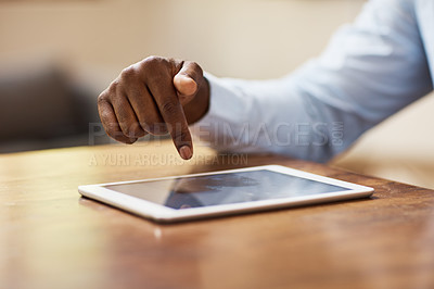 Buy stock photo Cropped shot of an unrecognizable businessman using a tablet in his home office