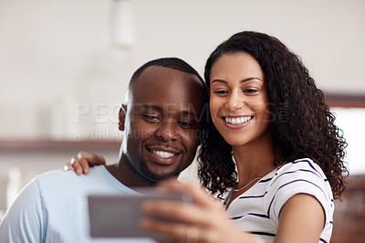 Buy stock photo Cropped shot of a young married couple taking a selfie in the kitchen at home